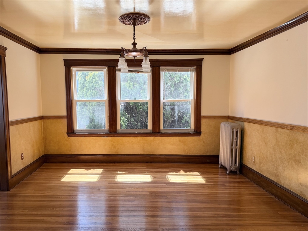 157 Hillside Street, Unit 2 Boston, MA 02120 - Photo 1 of 17 a view of empty room with wooden floor and fan