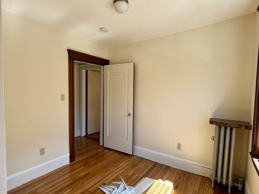 157 Hillside Street, Unit 2 Boston, MA 02120 - Photo 11 of 17 a view of empty room with wooden floor