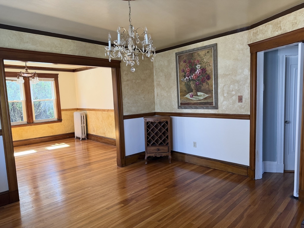 157 Hillside Street, Unit 2 Boston, MA 02120 - Photo 3 of 17 a view of a room with wooden floor chandelier and windows