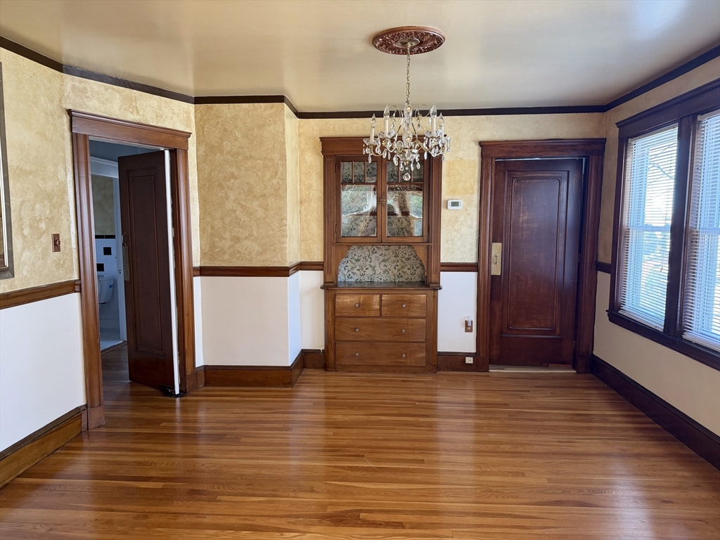 157 Hillside Street, Unit 2 Boston, MA 02120 - Photo 4 of 17 a view of a hallway with wooden floor and chandelier
