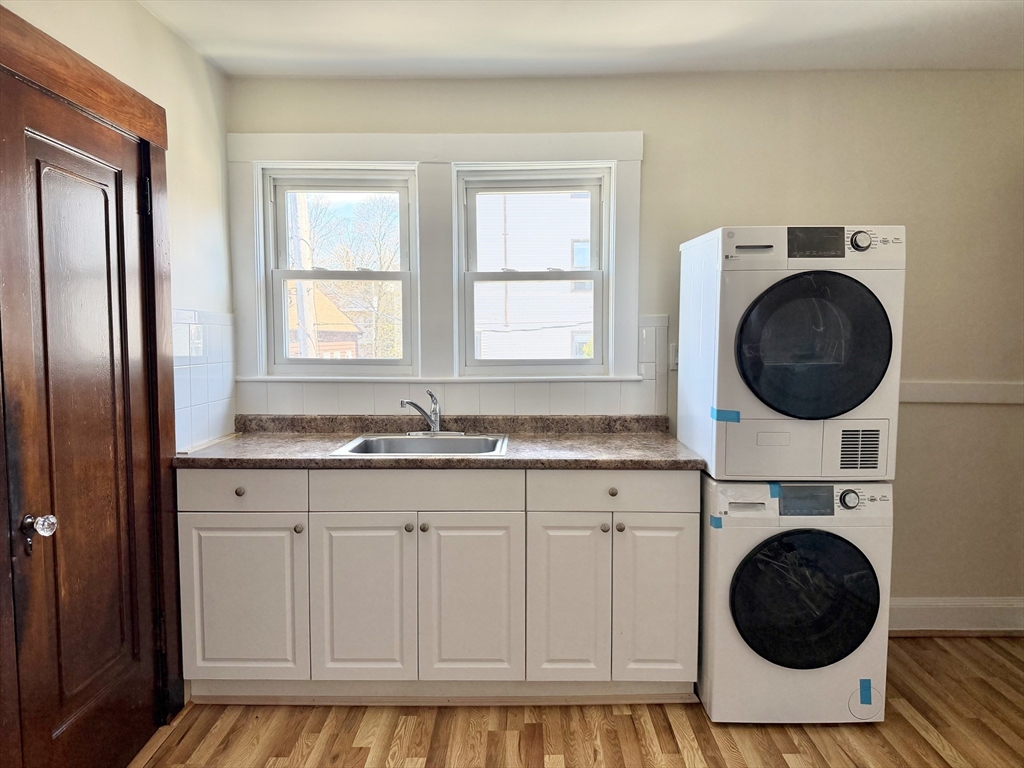 157 Hillside Street, Unit 2 Boston, MA 02120 - Photo 5 of 17 a bathroom with a sink a washer and dryer