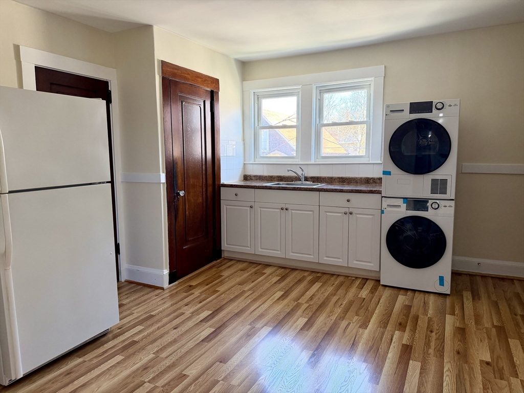 157 Hillside Street, Unit 2 Boston, MA 02120 - Photo 6 of 17 a view of a kitchen with a washer and dryer
