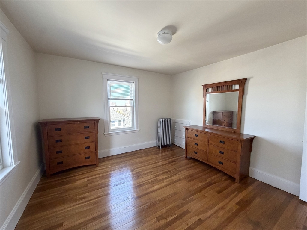 157 Hillside Street, Unit 2 Boston, MA 02120 - Photo 9 of 17 a room with furniture and wooden floor