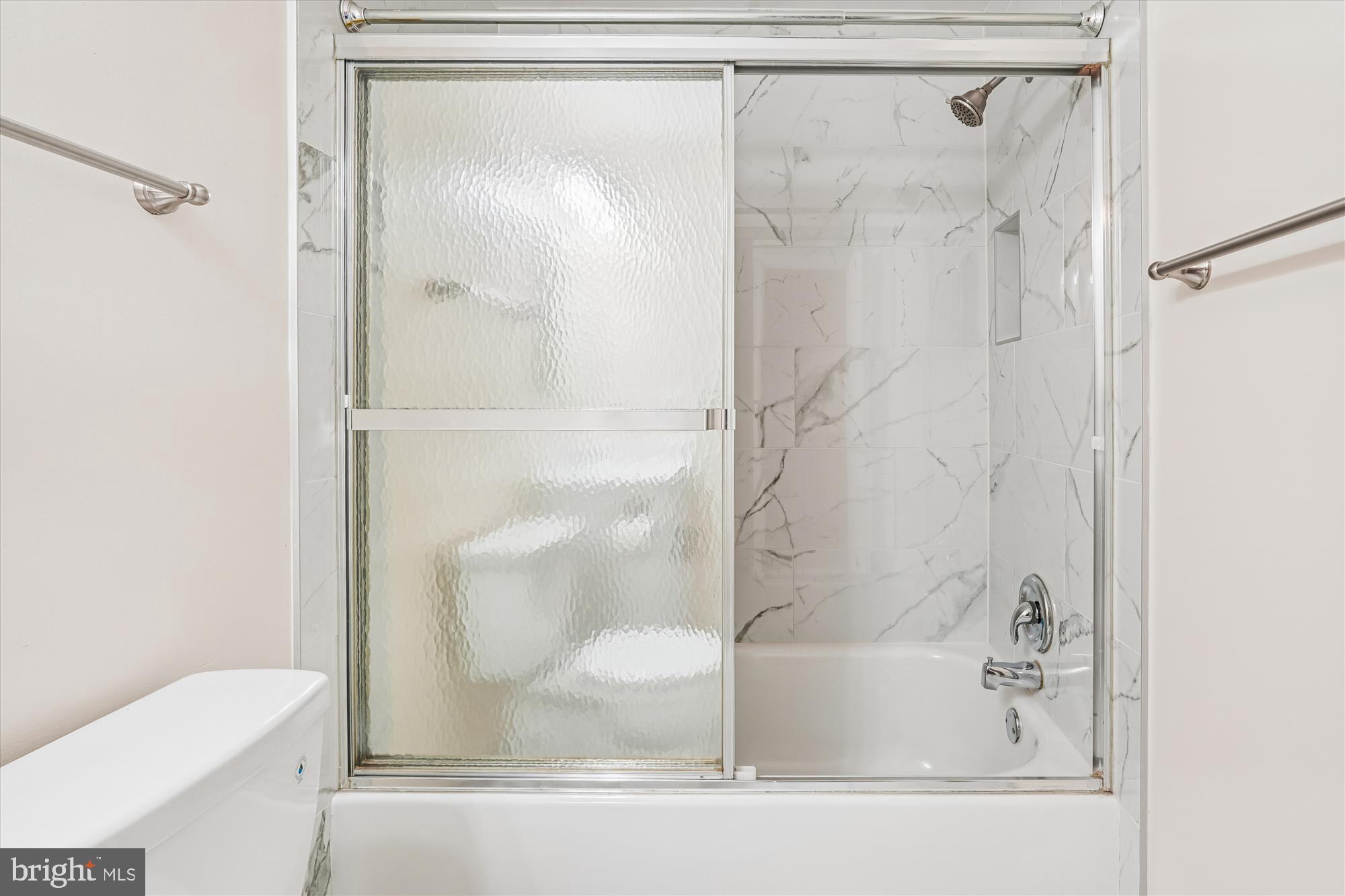 10602 Chisholm Landing Terrace Gaithersburg, MD 20878 - Photo 17 of 46 a bathroom with a glass shower door