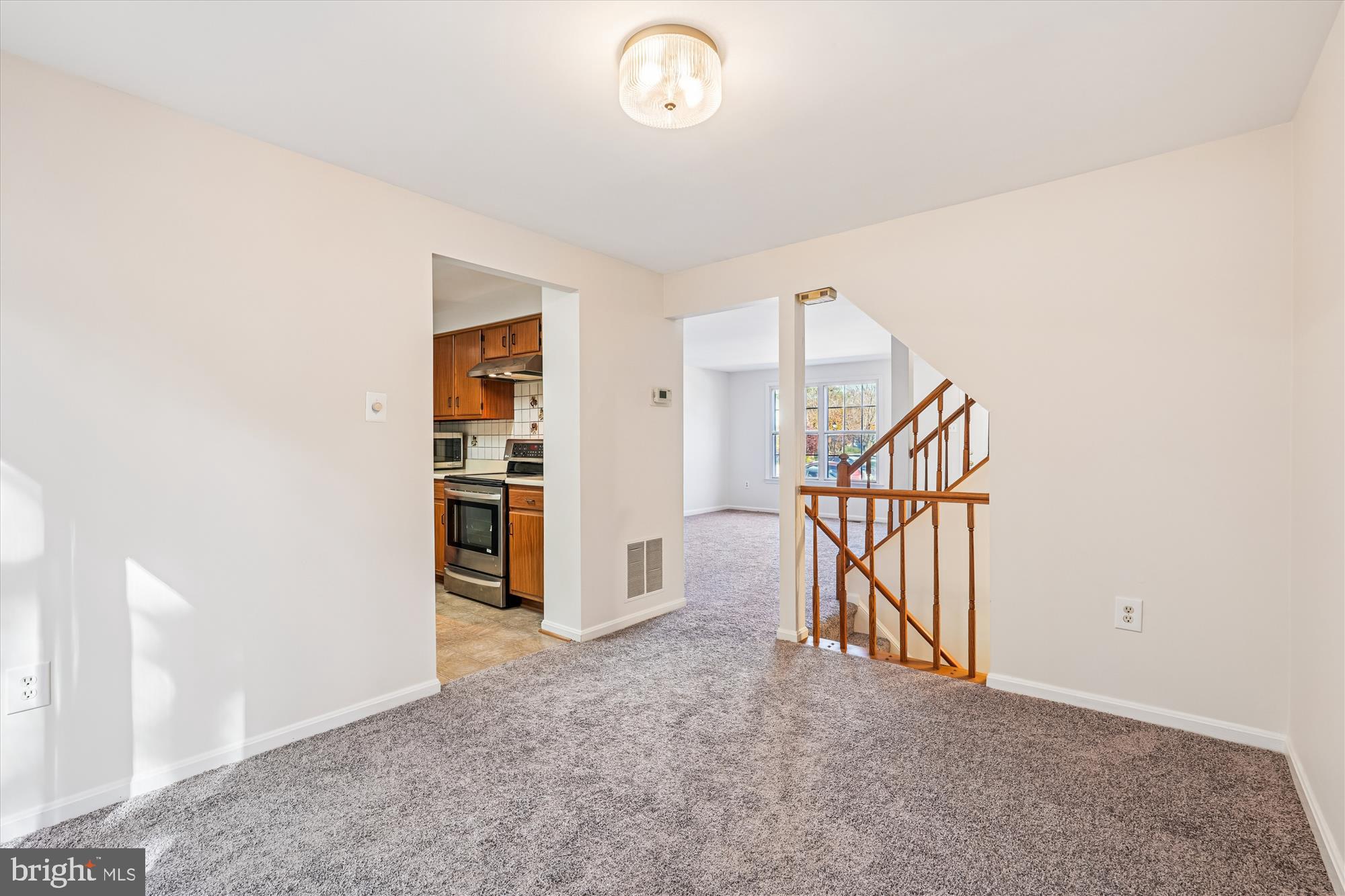 10602 Chisholm Landing Terrace Gaithersburg, MD 20878 - Photo 4 of 46 an empty room with staircase and a chandelier