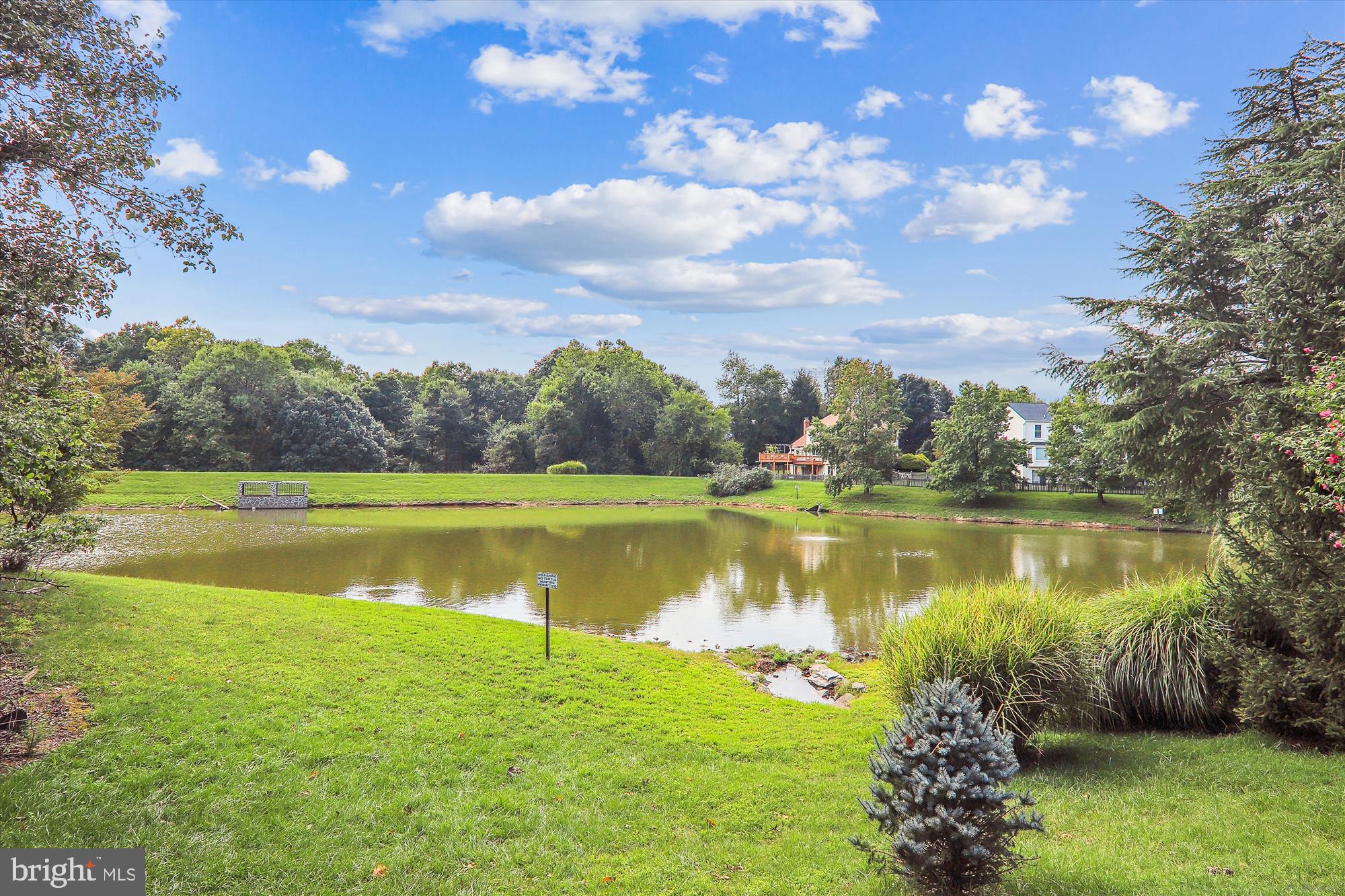 10602 Chisholm Landing Terrace Gaithersburg, MD 20878 - Photo 42 of 46 a view of a lake with a yard