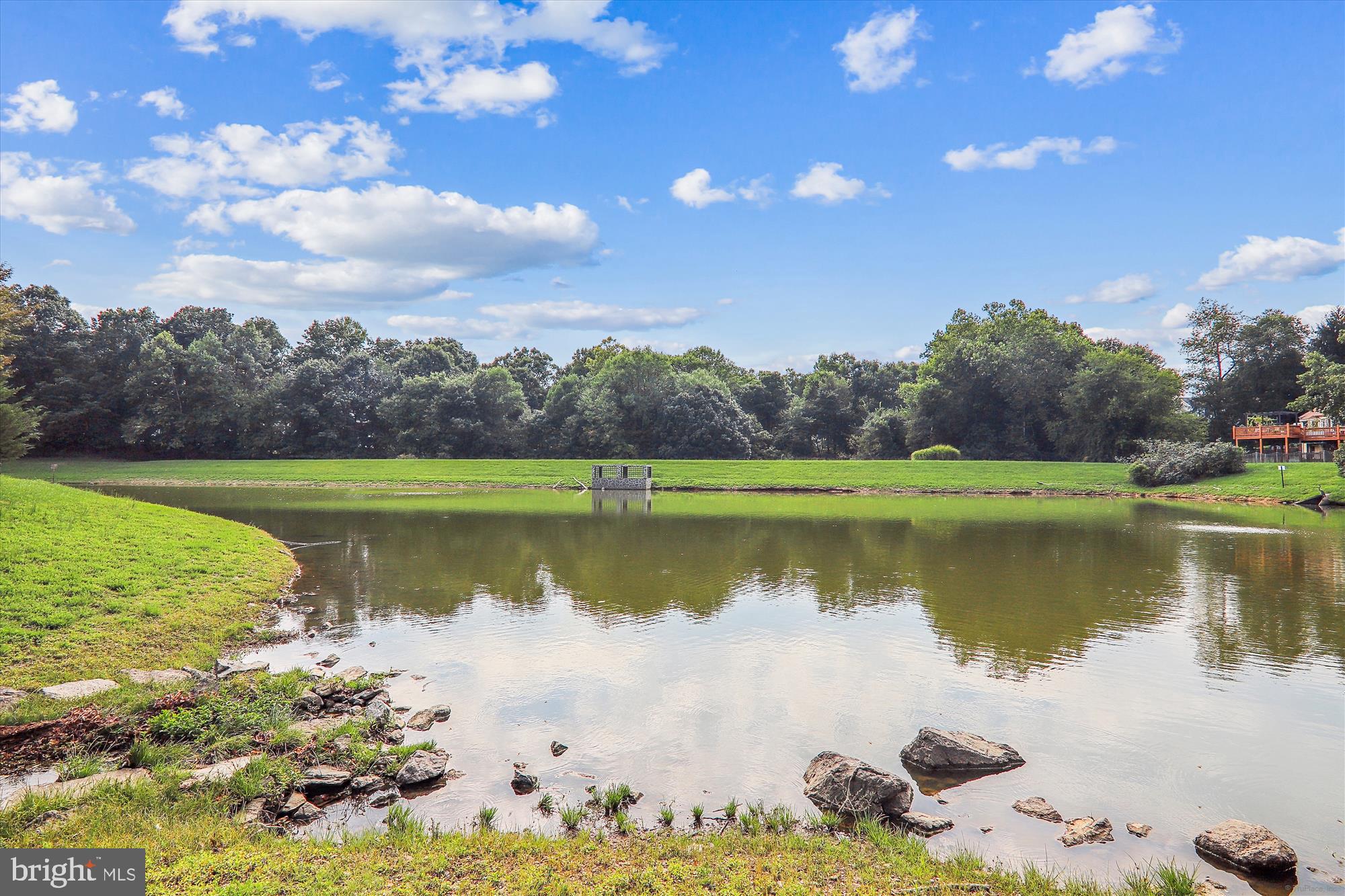 10602 Chisholm Landing Terrace Gaithersburg, MD 20878 - Photo 43 of 46 a view of a lake with a yard