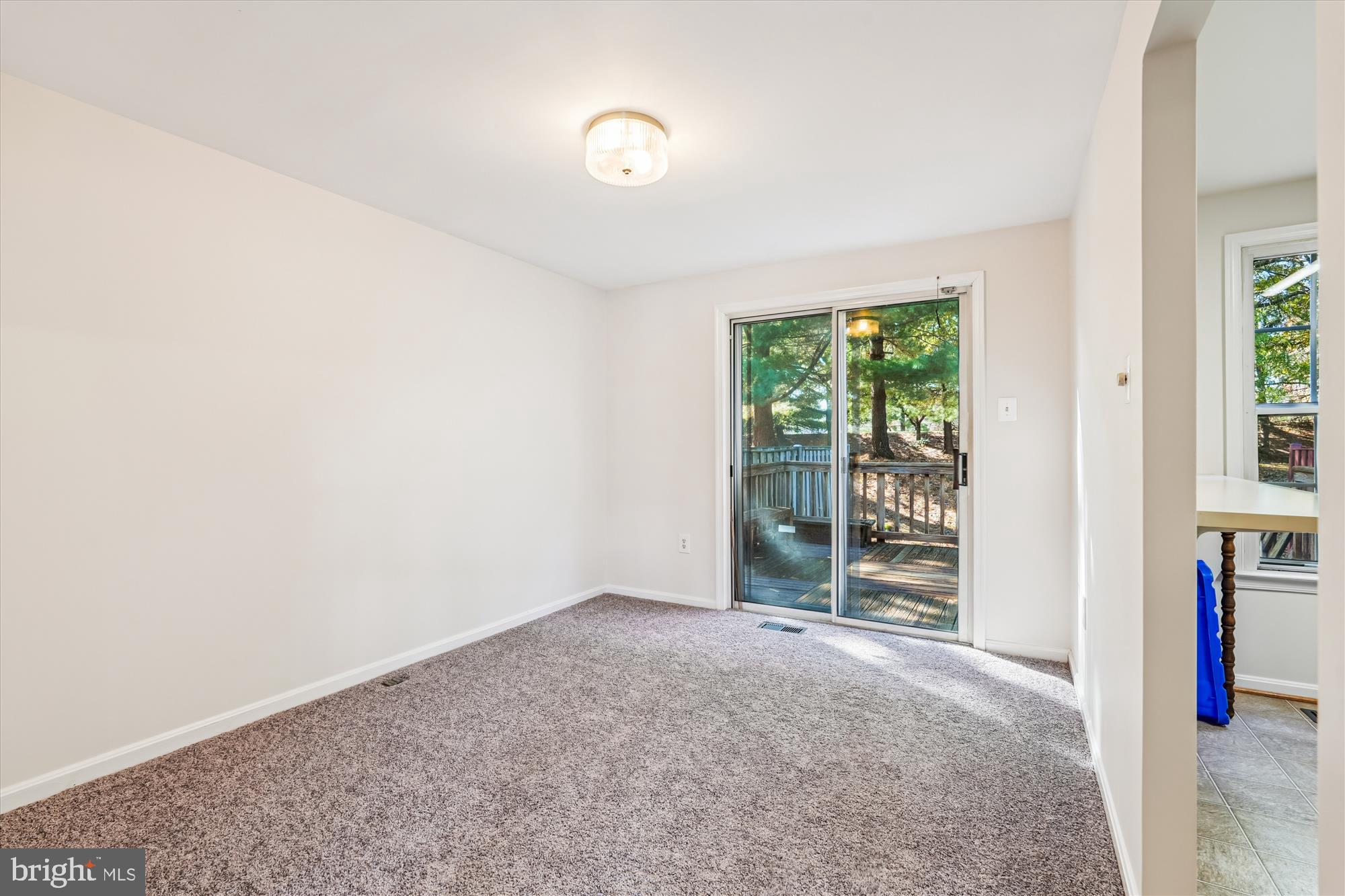 10602 Chisholm Landing Terrace Gaithersburg, MD 20878 - Photo 6 of 46 an empty room with floor to ceiling window and an outdoor view