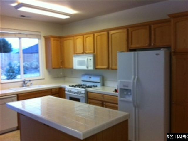 876 North University Park Loop Reno, NV 89512 - Photo 2 of 9 a kitchen with a refrigerator a stove a sink and a window