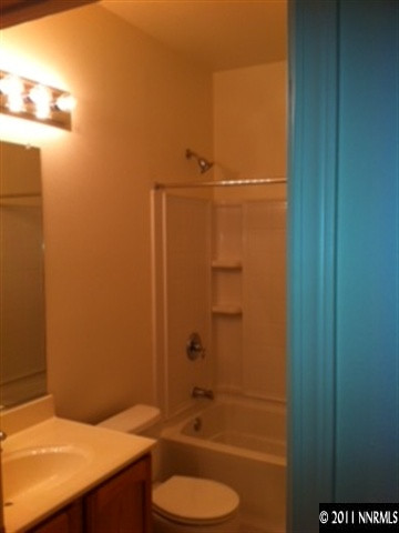 876 North University Park Loop Reno, NV 89512 - Photo 6 of 9 a bathroom with a granite countertop sink and a mirror