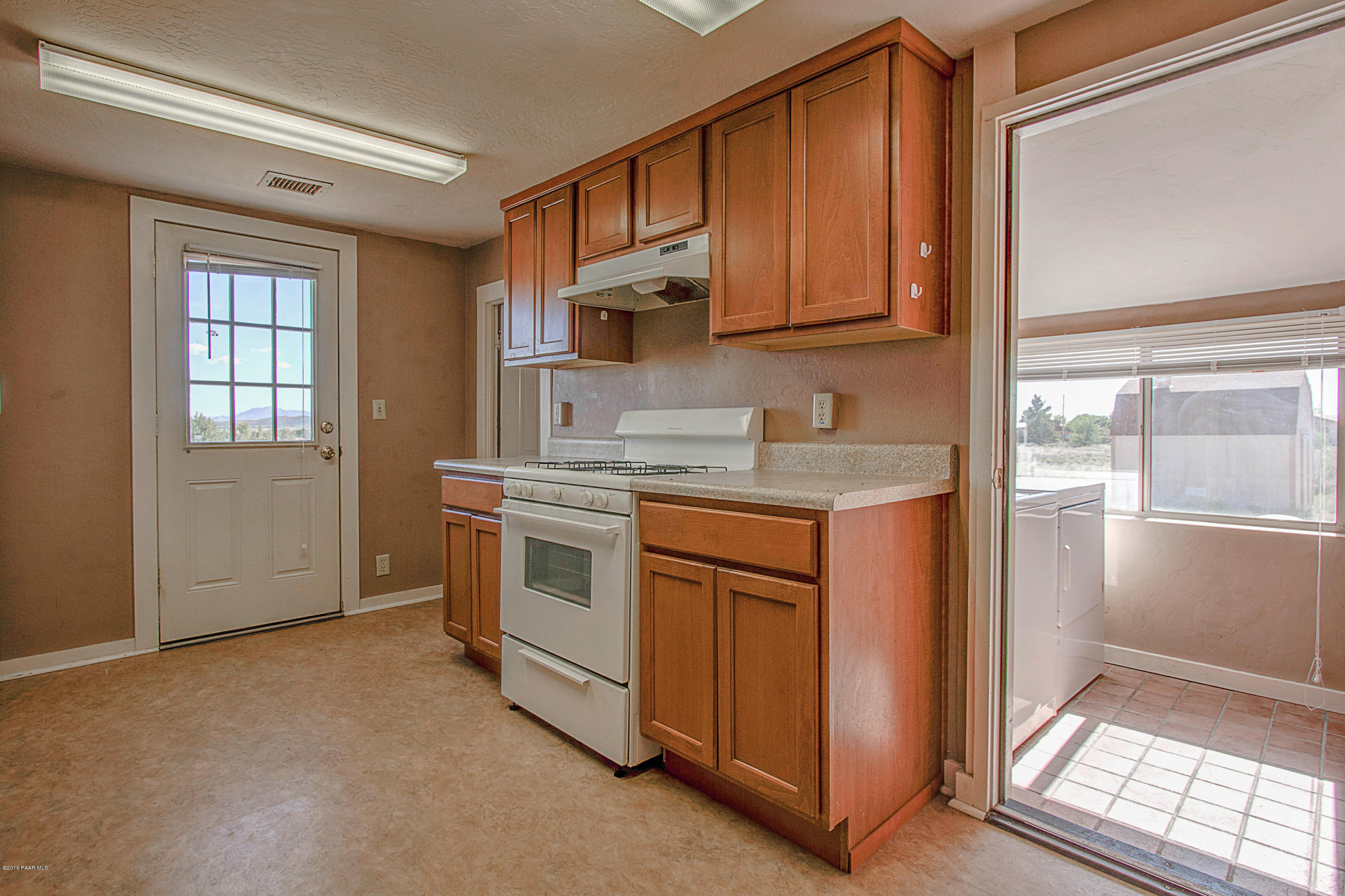 575 West Iris Road Paulden, AZ 86334 - Photo 11 of 18 a kitchen with stainless steel appliances granite countertop a stove a sink and a refrigerator