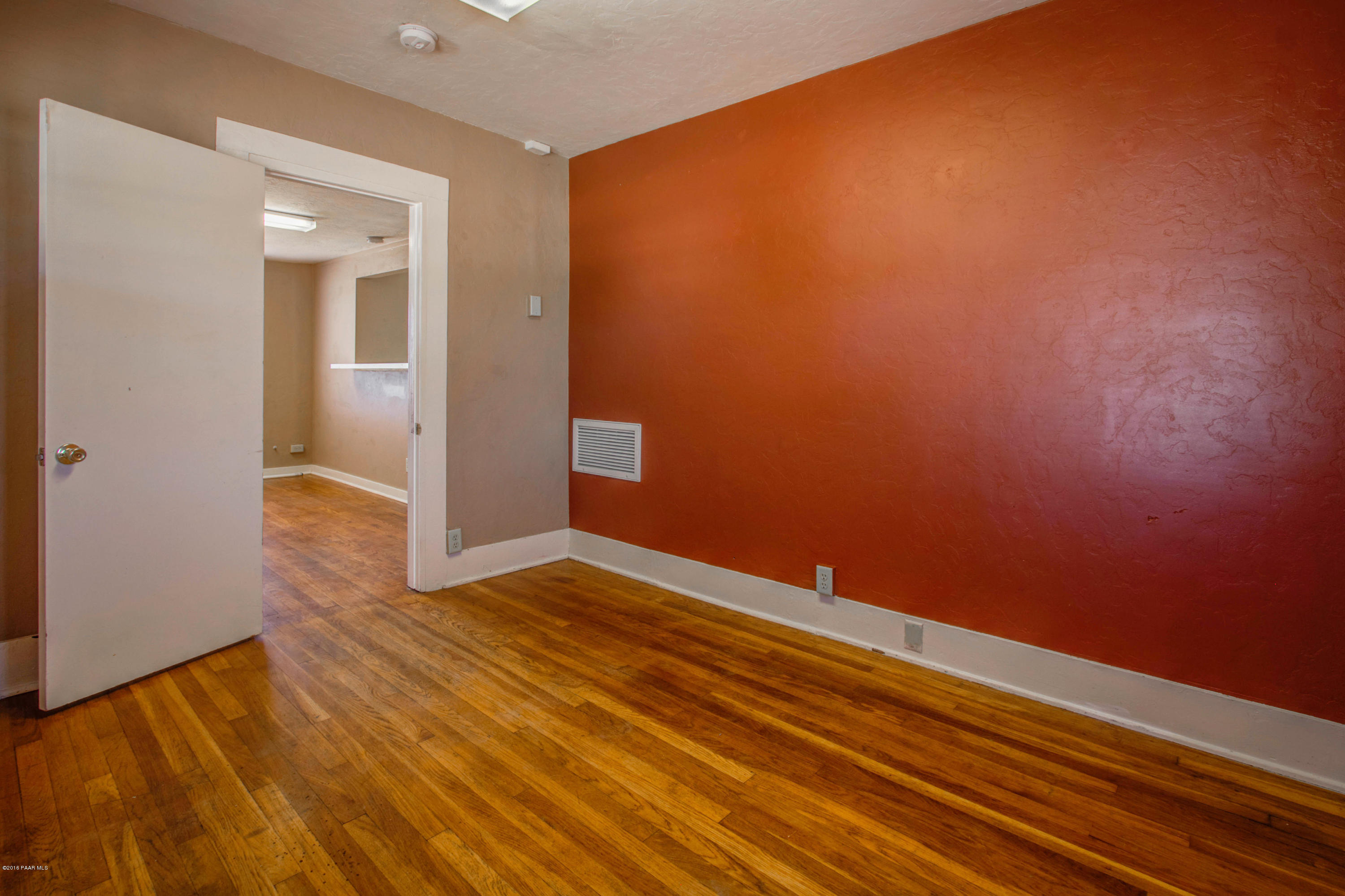 575 West Iris Road Paulden, AZ 86334 - Photo 9 of 18 an empty room with wooden floor and windows