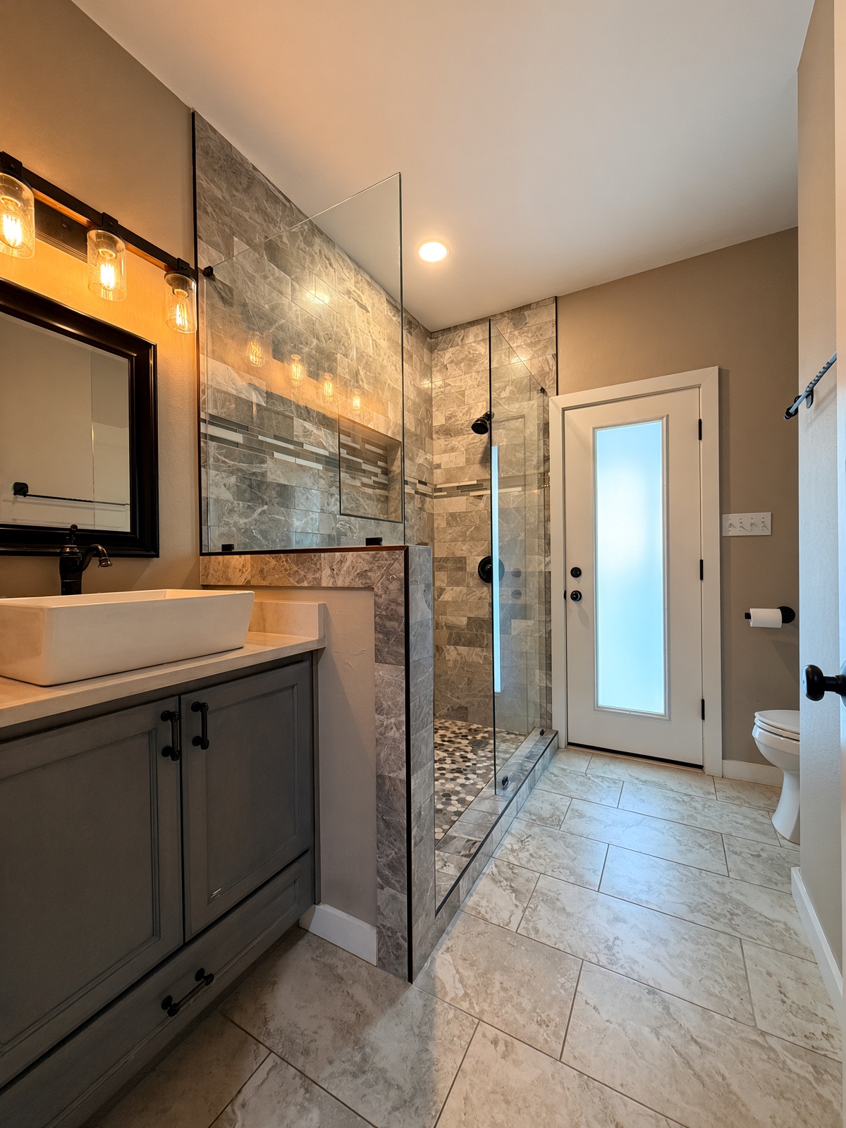 19005 White Rim Trail Jonestown, TX 78645 - Photo 15 of 39 A contemporary bathroom features a glass-enclosed walk-in shower alongside a stylish vanity setup.