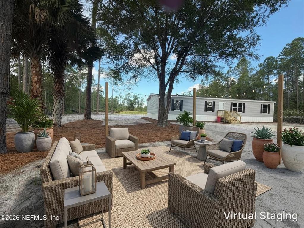 114 Nutmeg Trail Interlachen, FL 32148 - Photo 31 of 33 a group of couches sitting in a courtyard with a fire pit