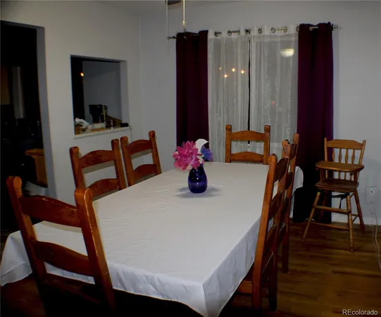 a dining room with furniture and wooden floor