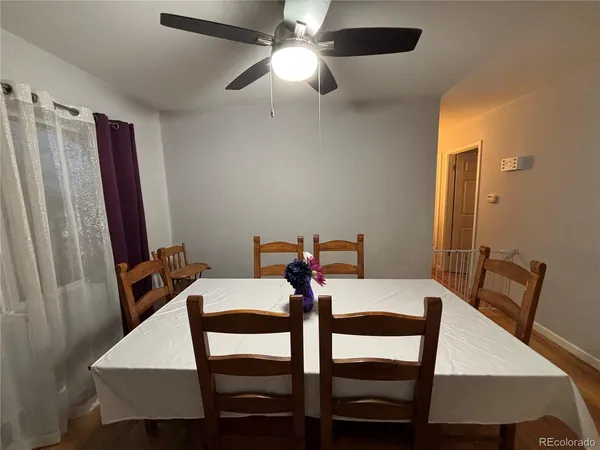 a view of a dining room with furniture and wooden floor
