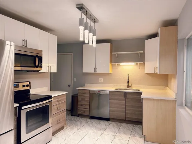 a kitchen with a sink a stove and cabinets