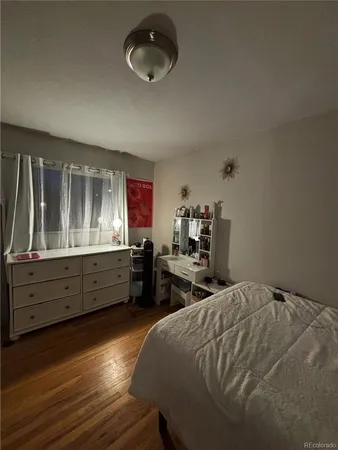 a bed room with a bed and a dresser