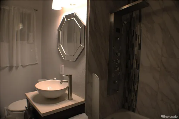 a bathroom with a toilet sink and mirror