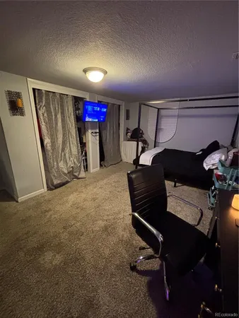 a bedroom with bed and a flat screen tv