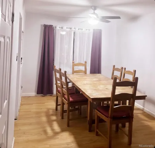 a view of a dining room with furniture and window