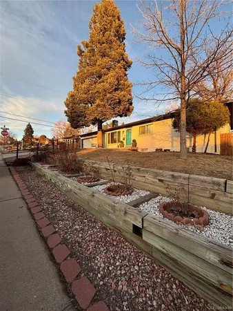 a view of a yard with wooden fence