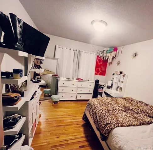 a bedroom with furniture and a book shelf