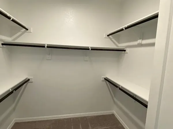 a kitchen with stainless steel appliances granite countertop a sink a stove and a wooden floor