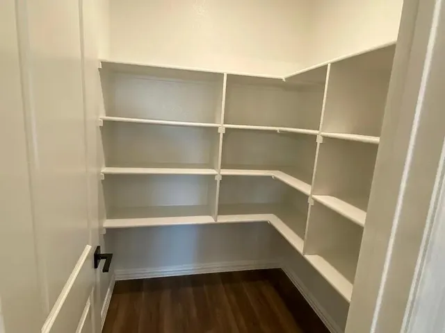 a kitchen with granite countertop a sink a counter space appliances and cabinets