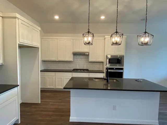 a kitchen with sink and window