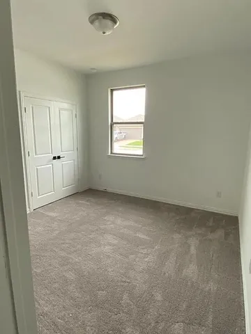 a view of a field with wooden fence