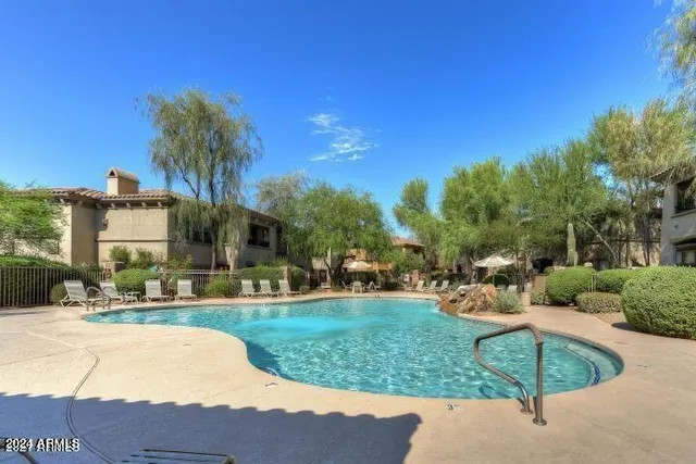 a view of a swimming pool and lounge chairs