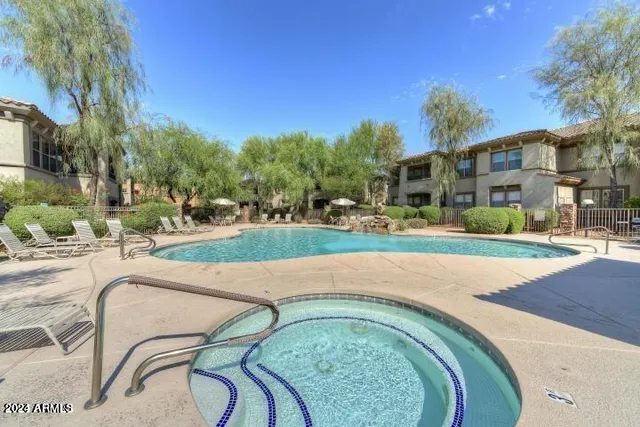 a swimming pool with outdoor seating and yard