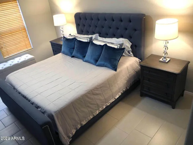 a bed sitting in a bedroom next to a window