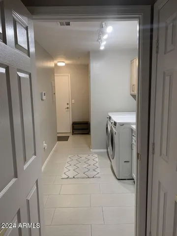 a view of a hallway with a washer and dryer