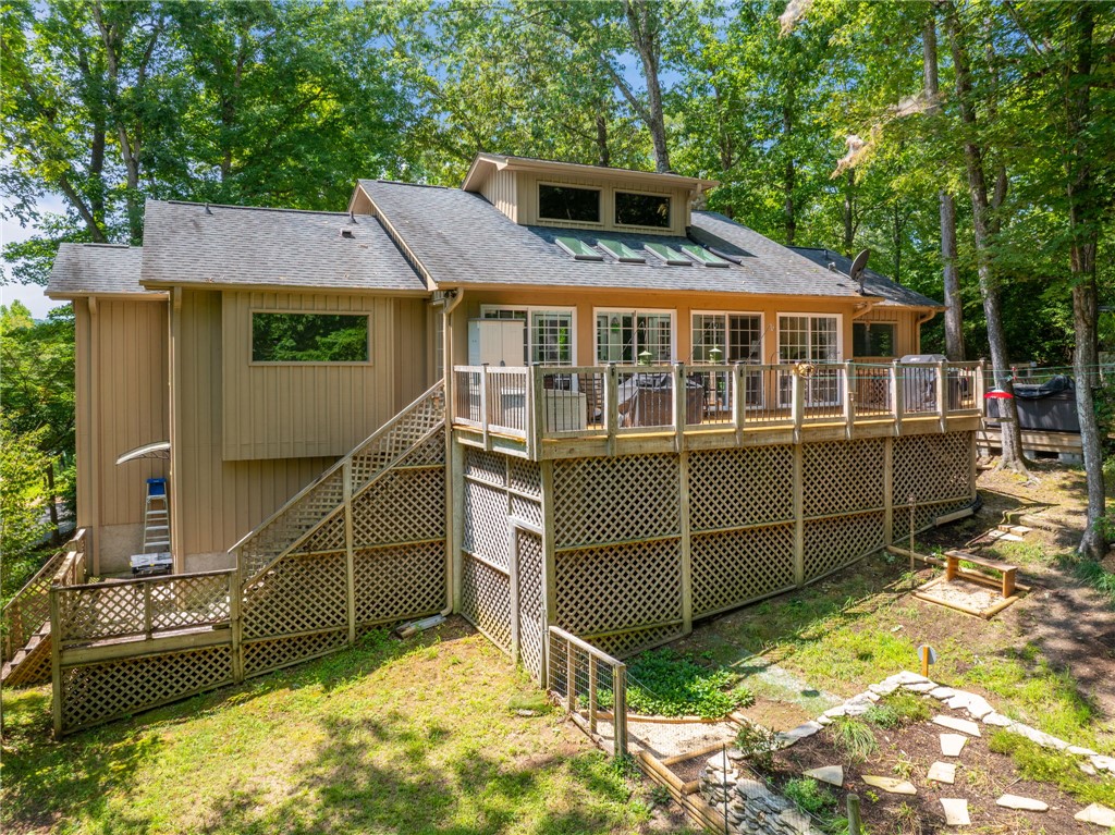 300 Whispering Falls Road Pickens, SC 29671 - Photo 24 of 41 A spacious wooden deck overlooks the grassy yard surrounded by mature trees.