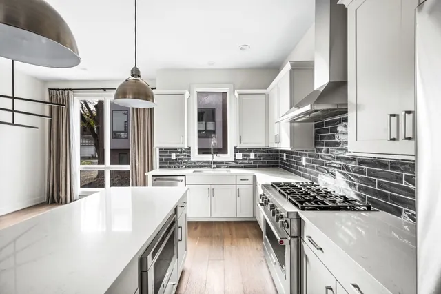 a kitchen with stainless steel appliances granite countertop a stove and a sink