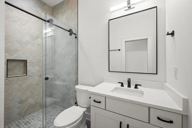 a bathroom with a sink toilet and shower