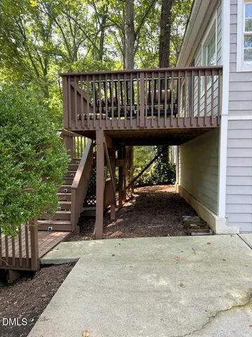 a view of a wooden deck with a yard