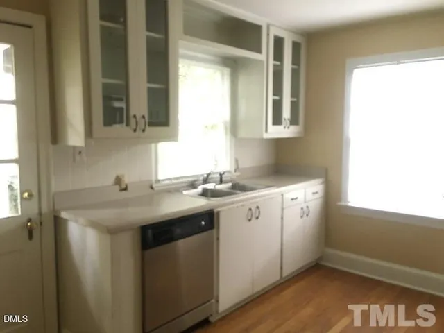 a utility room with two sink and a window