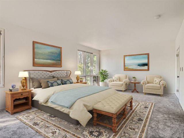 a bedroom with a bed a couch and a window
