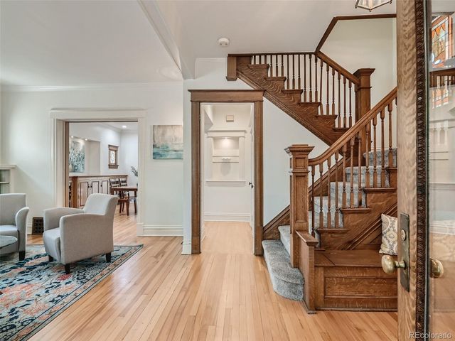 a view of entryway and hall with wooden floor