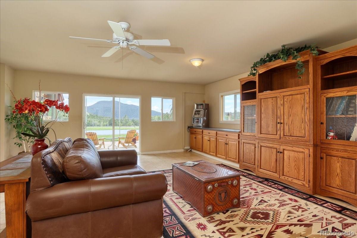 23391 Pleasant Park Road Conifer, CO 80433 - Photo 27 of 40 a living room with furniture and a large window