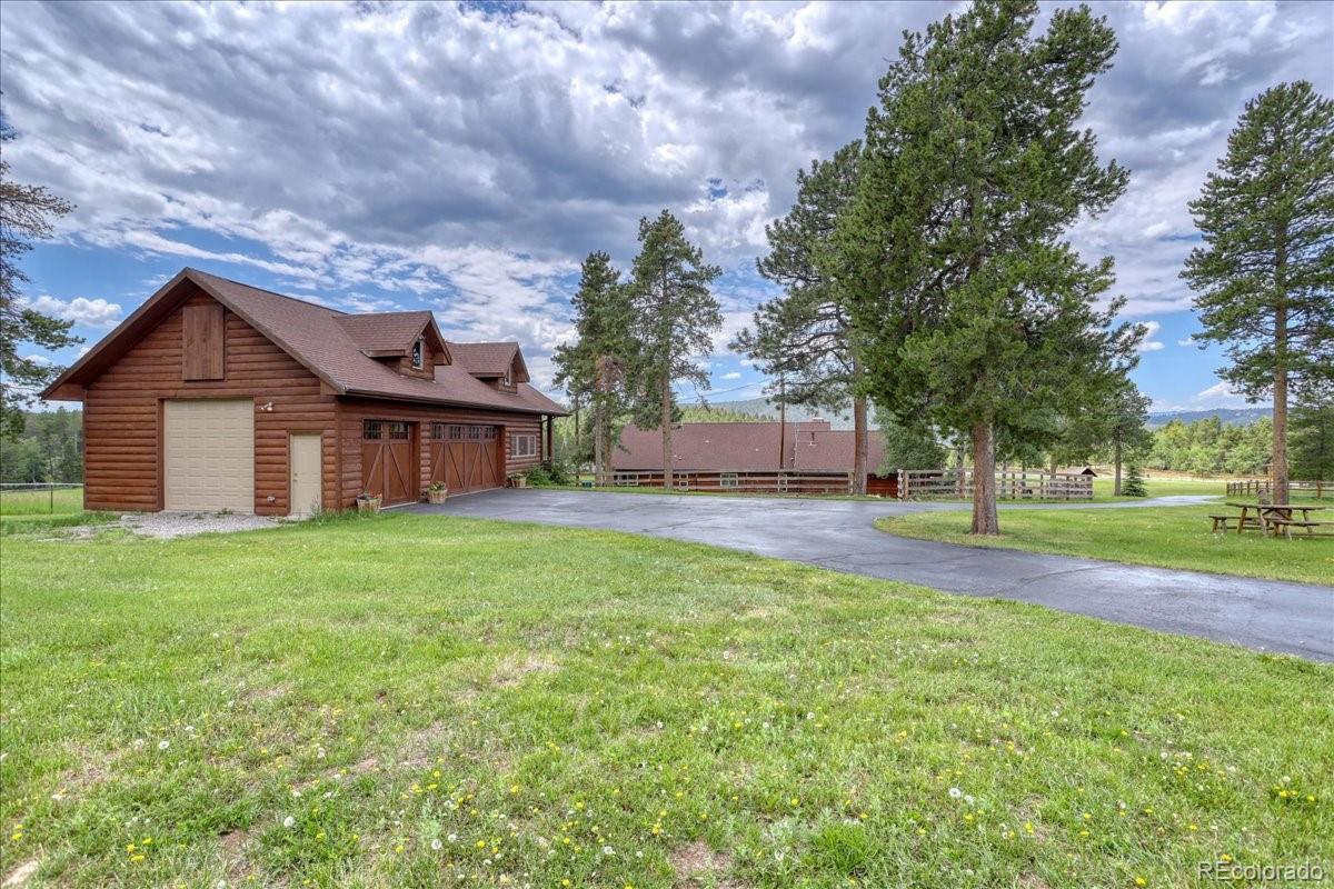23391 Pleasant Park Road Conifer, CO 80433 - Photo 8 of 40 a view of a house with backyard and trees