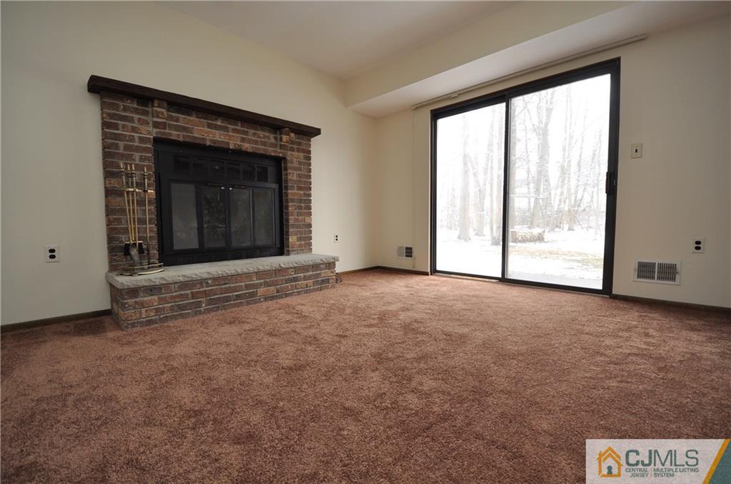 449 Cottrell Road Old Bridge, NJ 08857 - Photo 13 of 17 a view of an empty room with a fireplace and a window