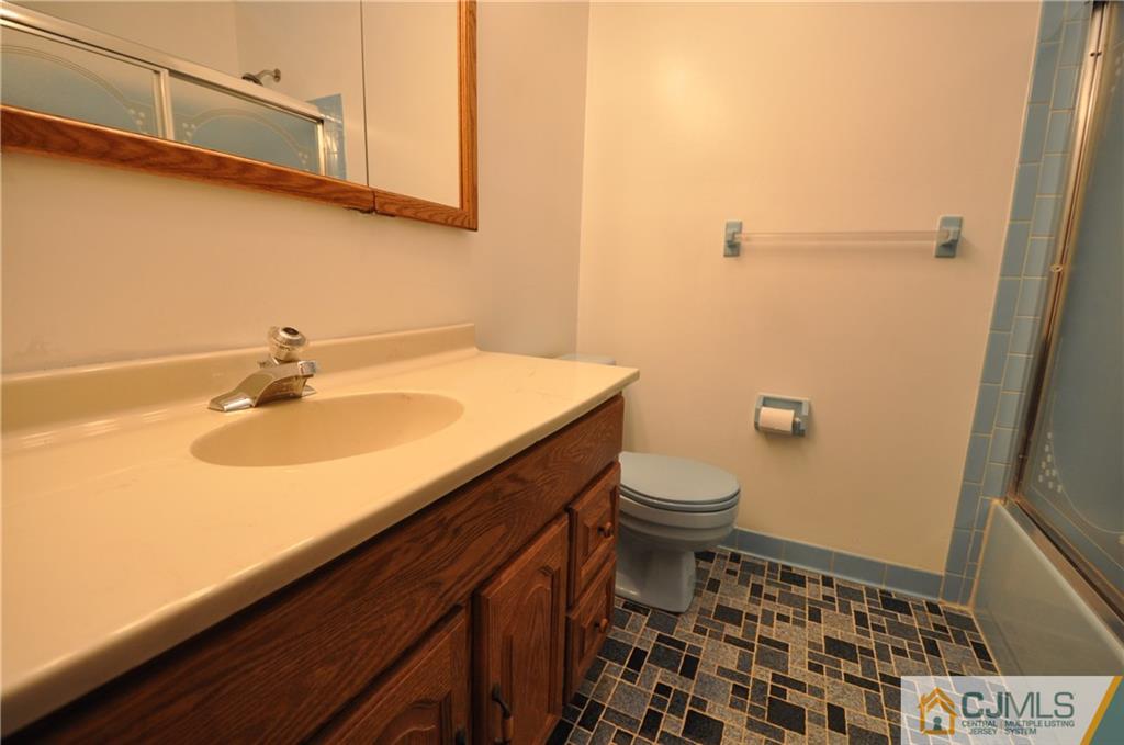 449 Cottrell Road Old Bridge, NJ 08857 - Photo 15 of 17 a bathroom with a sink a toilet and shower