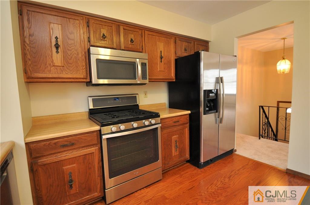 449 Cottrell Road Old Bridge, NJ 08857 - Photo 6 of 17 a kitchen with stainless steel appliances granite countertop a refrigerator stove and microwave