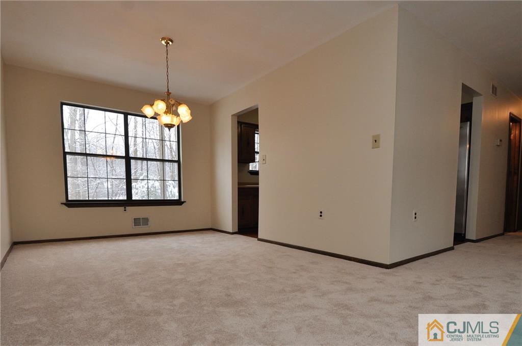 449 Cottrell Road Old Bridge, NJ 08857 - Photo 8 of 17 a view of an empty room with window and chandelier fan