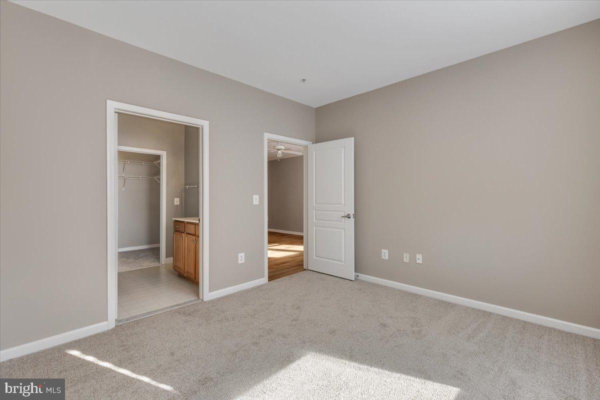 12001 Market Street, Unit 257 Reston, VA 20190 - Photo 11 of 33 a view of an empty room with closet and a bathroom