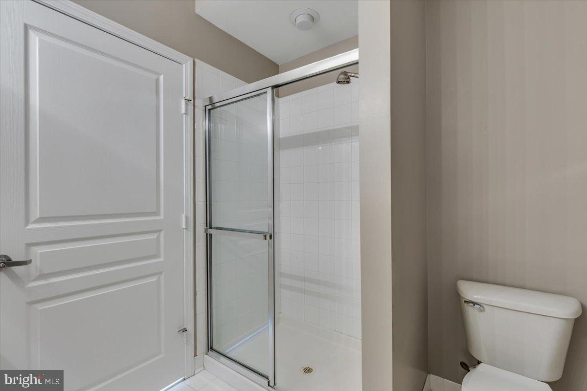 12001 Market Street, Unit 257 Reston, VA 20190 - Photo 13 of 33 a bathroom with a shower and toilet